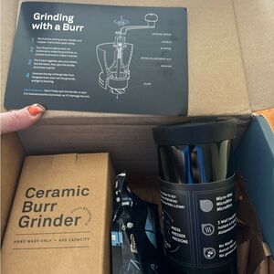 Coffee grinder, cup and coffee